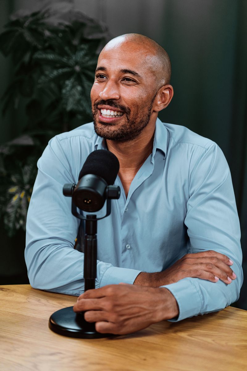 Podcast host smiling at the microphone